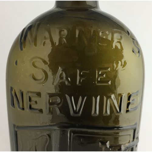 660 - WARNERS SAFE NERVINE BOTTLE. 9.5ins tall. One pint, olive green glass, sloping shoulders, short neck... 