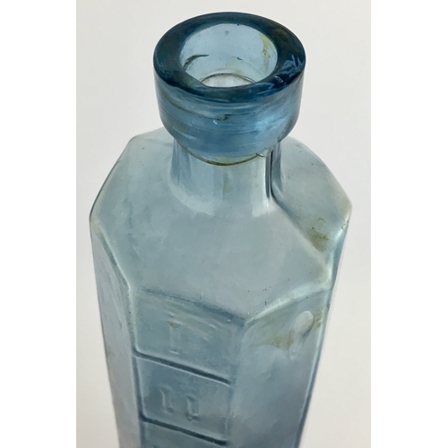 667 - OCTAGONAL PHARMACY MEASURE BOTTLE. 6.75ins tall. octagonal shape, pale blue glass, embossed with Rom... 