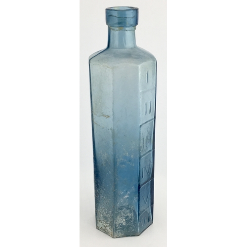 667 - OCTAGONAL PHARMACY MEASURE BOTTLE. 6.75ins tall. octagonal shape, pale blue glass, embossed with Rom... 