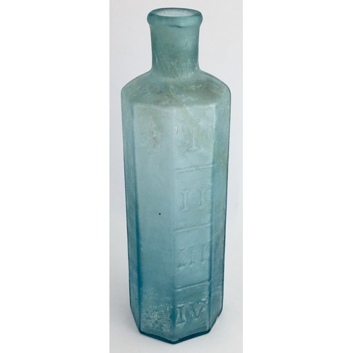 668 - OCTAGONAL PHARMACY MEASURE BOTTLE. 6.25ins tall. Octagonal shape, ice blue glass, embossed with Roma... 