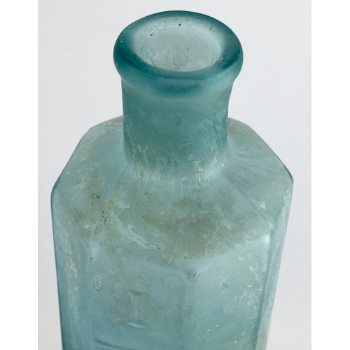 668 - OCTAGONAL PHARMACY MEASURE BOTTLE. 6.25ins tall. Octagonal shape, ice blue glass, embossed with Roma... 