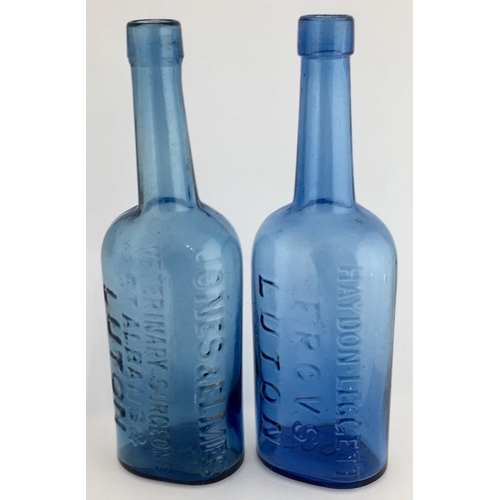 669 - LUTON VETERINARY BOTTLES DUO. 8.25ins tall. Blue glass, rounded shoulders, long necks, one JONES & E... 