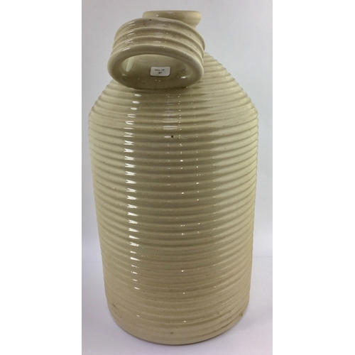 705 - POISON FLAGON. 13ins tall. Straight sided flagon with deep horizontal ribbing, off white glaze, rear... 