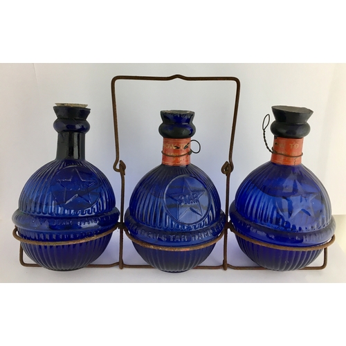 612 - HARDENS STAR FIRE GRENADES IN RACK. Trio of cobalt blue glass spherical bodied grenades, each 6.5ins... 