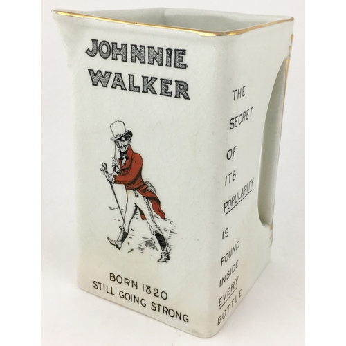 29 - JOHNNIE WALKER WATER JUG. 6ins tall. Square shaped jug with familiar striding Johnnie Walker image t... 