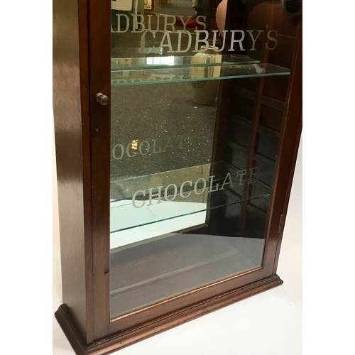 53 - CADBURY’S CHOCOLATE FRONT LOADING CABINET. 20.75 by 43ins tall. Origianl top finial & etched glass f... 