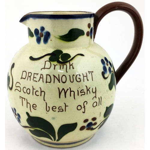 111 - DREADNAUGHT WHISKY WATER JUG. 6.25ins tall. Torquayware pottery style jug with piped decoration each... 