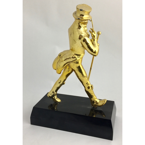 124 - JOHNNIE WALKER BACK BAR STATUETTE. 11.5ins tall. Extremely heavy cast gold coloured figure on black ... 