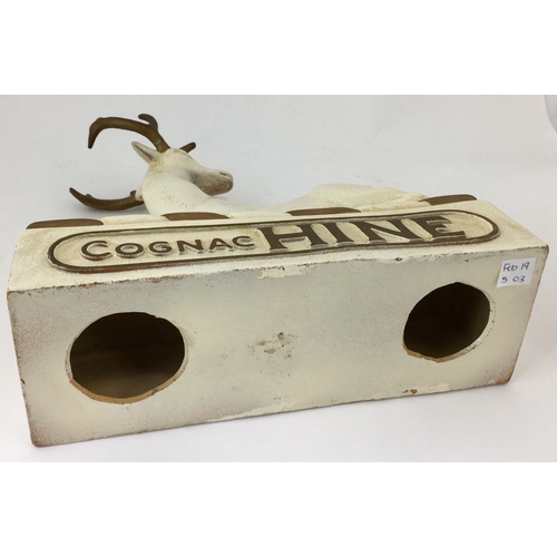 203 - COGNAC HINE ADVERTISING FIGURE. 11.3ins tall. Rubberoid seated hind atop plinth. Few ageing/ wear ma... 