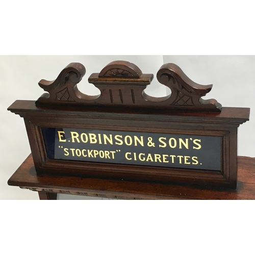 243 - E. ROBINSON & SONS “STOCKPORT” CIGARETTES CABINET. 34.25 by 21.5ins. Highly ornate wooden display ci... 