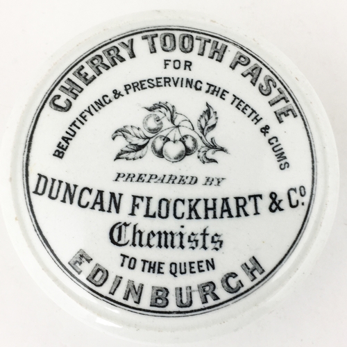 485 - EDINBURGH CHERRY TOOTH PASTE POT LID. 3.2ins diam.  Cherries & leaves pictorial above middle. Bottom... 