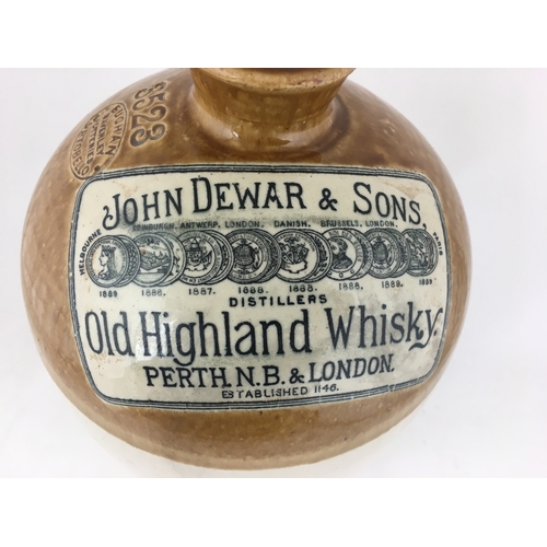 489 - DEWAR WHISKY FLAGON. 12ins tall, t.t. rearhandle,round shouldered cylindrical shape. Row of prize me... 