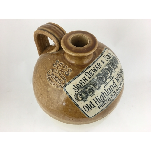 489 - DEWAR WHISKY FLAGON. 12ins tall, t.t. rearhandle,round shouldered cylindrical shape. Row of prize me... 