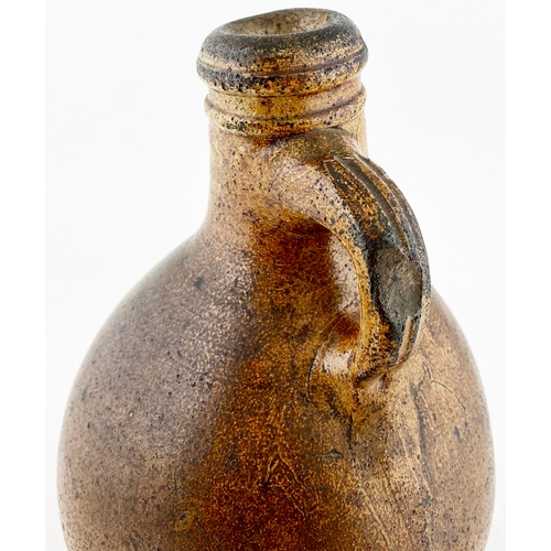 495 - BELLARMINE TYPE FLAGON. 10.5ins tall, variating salt glaze, wonky neck, small rear handle. Delightfu... 