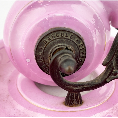 571 - CERAMIC SNAIL INKWELL. 5.5ins base diam. Bright pink snail shaped well set on a similar coloured bas... 