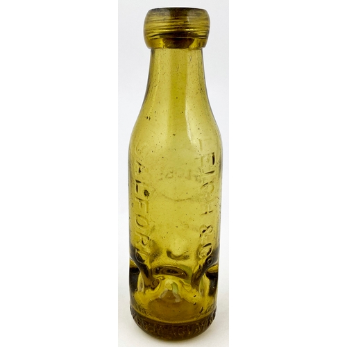 553 - SALFORD SYKES MACVAY PATENT BOTTLE. 7.25ins tall, amber glass. Six circular base indents, bottle lip... 