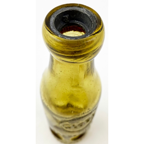 553 - SALFORD SYKES MACVAY PATENT BOTTLE. 7.25ins tall, amber glass. Six circular base indents, bottle lip... 