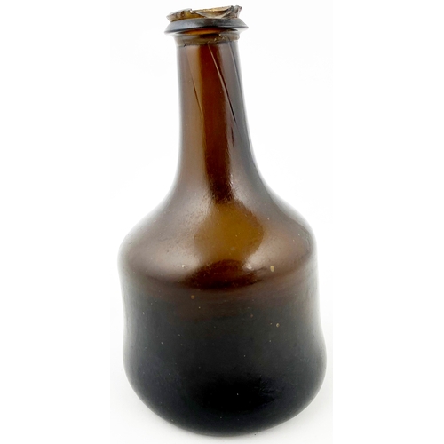 676 - EARLY ENGLISH SPLIT SIZE MALLET WINE BOTTLE. 6.4ins tall. Black/ dark amber glass. Long neck with st... 