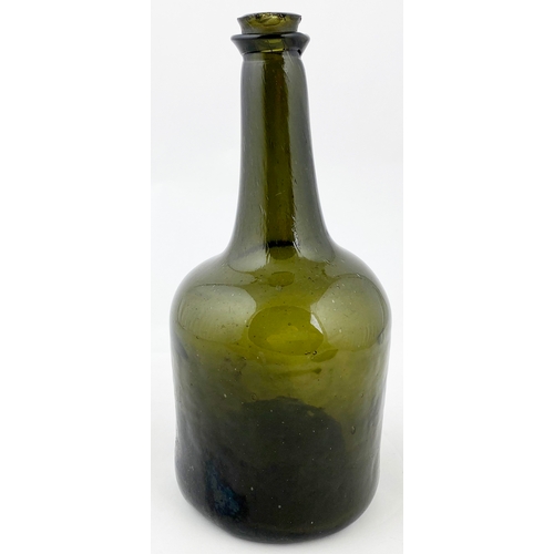 677 - EARLY SQUAT CYLINDER BODIED WINE BOTTLE.  9.4ins tall. Dark green glass, c. 1745-50, unusual kick up... 