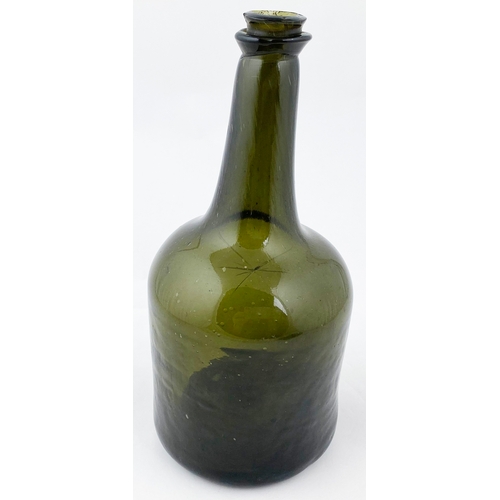 677 - EARLY SQUAT CYLINDER BODIED WINE BOTTLE.  9.4ins tall. Dark green glass, c. 1745-50, unusual kick up... 