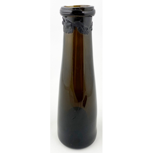 680 - TRUFFLE BOTTLE.9.5ins tall. Black/ green glass, tapered free blown form with strong string lip, base... 