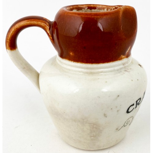 652 - CRAIGMILLAR CREAM JUG. 2.75ins tall. Brown top, lower white glaze, black transfer CRAIGMILLAR/ CREAM... 