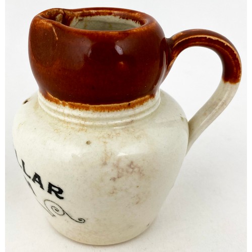 652 - CRAIGMILLAR CREAM JUG. 2.75ins tall. Brown top, lower white glaze, black transfer CRAIGMILLAR/ CREAM... 