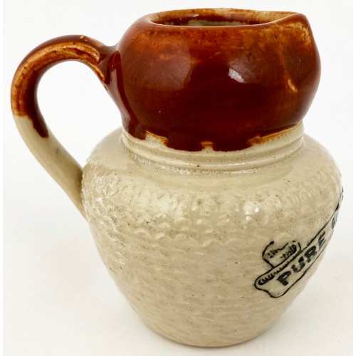 651 - PURE FRESH CREAM JUG. 2.5ins tall. Brown top lower cream glaze, unusually textured body, black trans... 