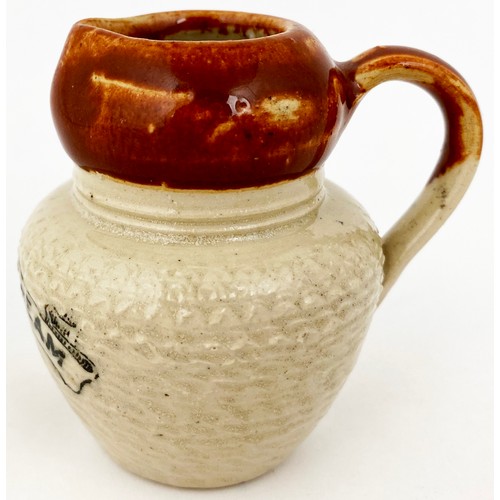 651 - PURE FRESH CREAM JUG. 2.5ins tall. Brown top lower cream glaze, unusually textured body, black trans... 