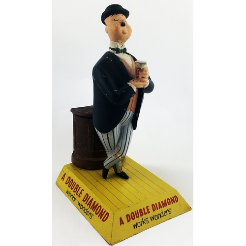 117 - DOUBLE DIAMOND BACK BAR FIGURE. 11.4ins tall. An amusing rubberoid multi-coloured figure of a dapper... 