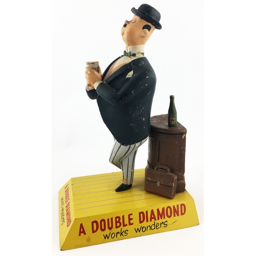 117 - DOUBLE DIAMOND BACK BAR FIGURE. 11.4ins tall. An amusing rubberoid multi-coloured figure of a dapper... 