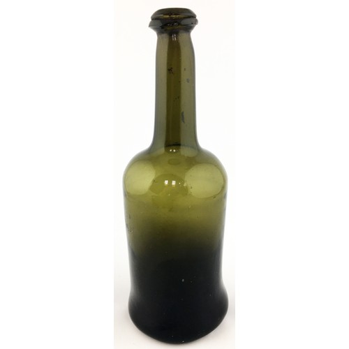 93A - FREEBLOWN WINE BOTTLE. 10.8ins tall. Heavy black glass veering to dark green where thinner. Overall ... 