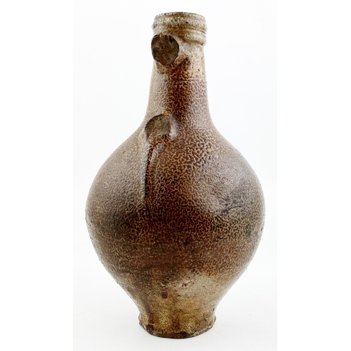 136 - BELLARMINE JUG.  9ins tall, speckled salt glaze body, narrow neck & foot section. Familiar bearded f... 