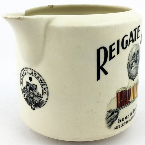 164 - REIGATE ALES WATER JUG. 4.3ins tall. Black and coloured transfer to both sides... beer is best/ MELL... 