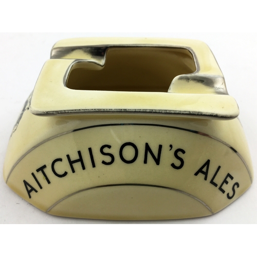 11 - AITCHISONS ALES ASHTRAY. 5ins x 4ins 8 sided base, cream with silver guilding black wording and tran... 