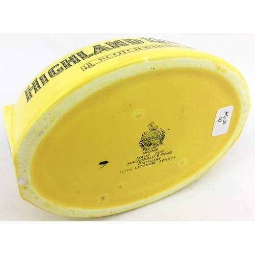 114 - HIGHLAND QUEEN SCOTCH WHISKY ASHTRAY. 4.75 by 3.5ins diam. Mustard coloured oval, black edging to to... 