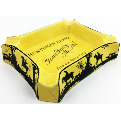 116 - HUNTSMAN BRAND ASHTRAY. 5.5 x 4.4ins Rectangular mustard coloured with lettering in centre, fox hunt... 