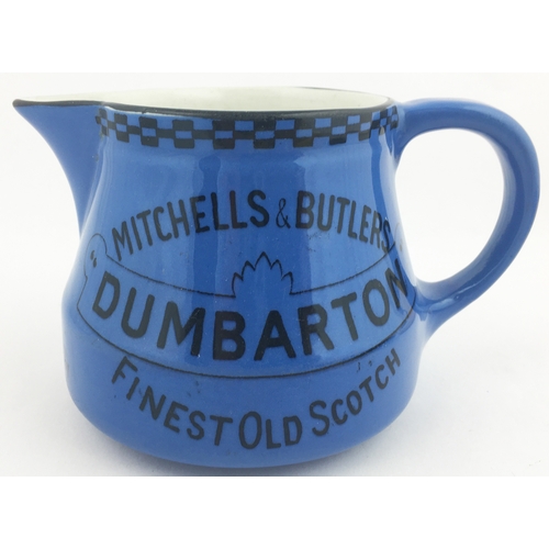 132 - DUMBARTON WHISKY JUG. 4ins tall. Blue coloured whisky jug  with Mitchells & Butlers black transfer t... 