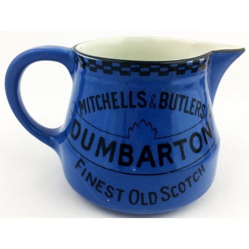 132 - DUMBARTON WHISKY JUG. 4ins tall. Blue coloured whisky jug  with Mitchells & Butlers black transfer t... 