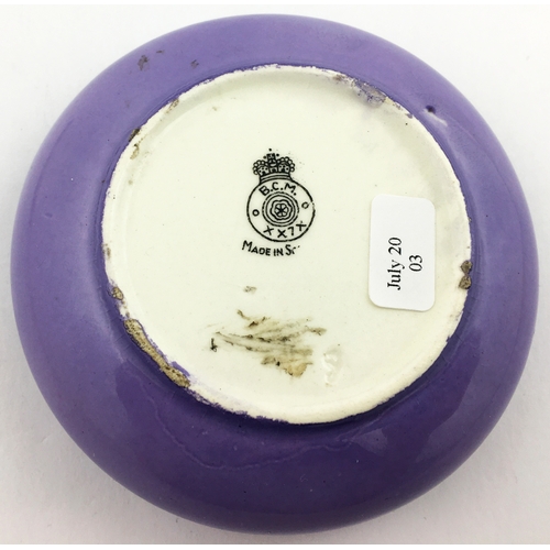 163 - HAPPY DAYS SCOTCH WHISKY ASHTRAY. 3.5 ins diam. Striking purple coloured glaze to outside of bowl wi... 