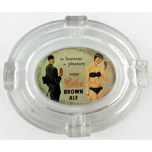 164 - BUTLERS WOLVERHAMPTON BROWN ALE GLASS OVAL ASHTRAY. 6 by 5ins. Glass ashtray with coloured label aff... 