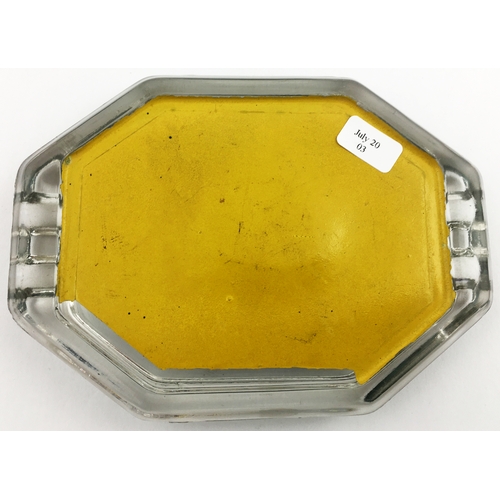 165 - RIZLA GLASS ASHTRAY. 5.25 by 3.75ins diam. Octagonal glass with green, gold and black paper print to... 