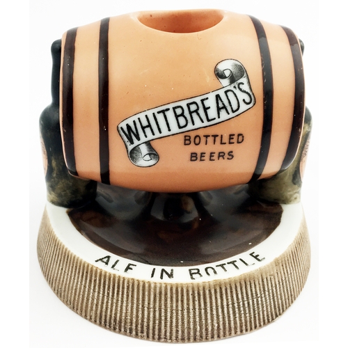 186 - HITBREADS BOTTLED BEERS MATCHSTRIKER ASHTRAY. 5ins diam. Side laying peach coloured barrel, supporti... 