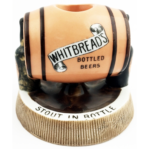 186 - HITBREADS BOTTLED BEERS MATCHSTRIKER ASHTRAY. 5ins diam. Side laying peach coloured barrel, supporti... 