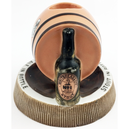 186 - HITBREADS BOTTLED BEERS MATCHSTRIKER ASHTRAY. 5ins diam. Side laying peach coloured barrel, supporti... 