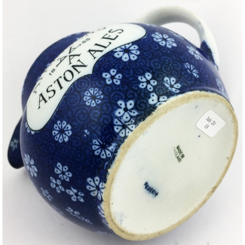 214 - 4.2ins tall. Dark blue floral body printed jug, white plaques carrying the black letters Atkinsons A... 