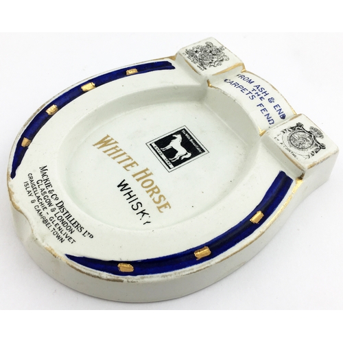 218 - WHITE HORSE WHISKY HORSESHOE SHAPED ASHTRAY. 5ins x 4.2ins. Flat form featuring coat of arms above &... 