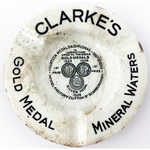 304 - CLARKES SCARBOROUGH GOLD MEDAL MINERAL WATERS ASHTRAY. 4.1ins diam. Black transferred lettering arou... 