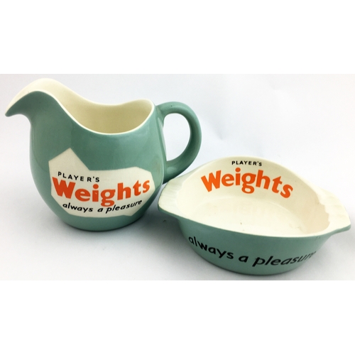 76 - PLAYERS WEIGHTS WATER JUG & ASHTRAY. 4.5 in tall jug & 5.8 diam. ashtray. Mint-green body glaze, bla... 