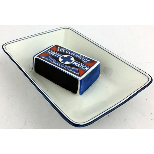 84 - BLUE CROSS SAFETY MATCH ASHTRAY. 5.2 x 3.8ins all white pottery with 3D coloured matchbox to centre,... 